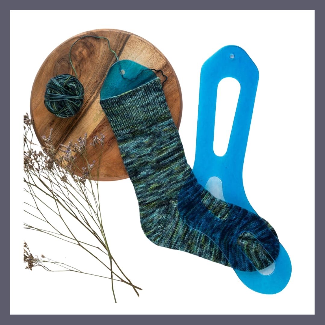 The Good Yarn Aqua Sock Blocker with yarn in green and blue