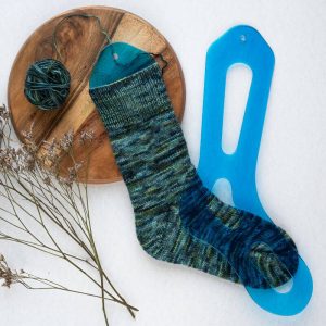 The Good Yarn Aqua Sock Blocker with yarn in green and blue
